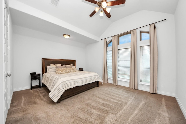 bedroom with multiple windows, vaulted ceiling, ceiling fan, and dark colored carpet