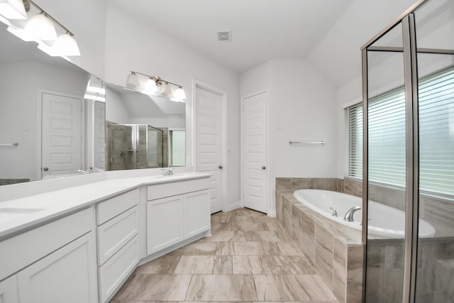 full bath featuring double vanity, vaulted ceiling, a sink, a shower stall, and a bath