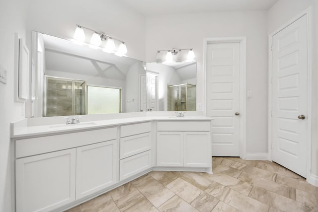 full bath featuring a stall shower, a sink, and double vanity