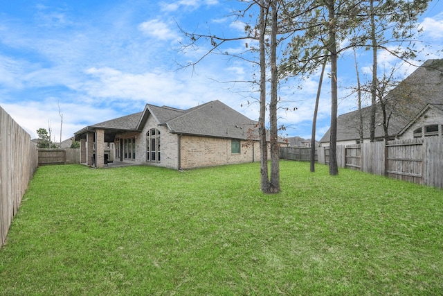 view of yard with a fenced backyard