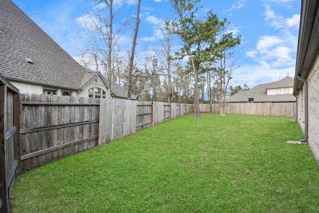 view of yard with a fenced backyard