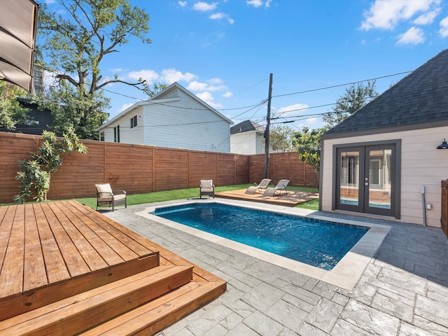 view of swimming pool featuring french doors and a patio