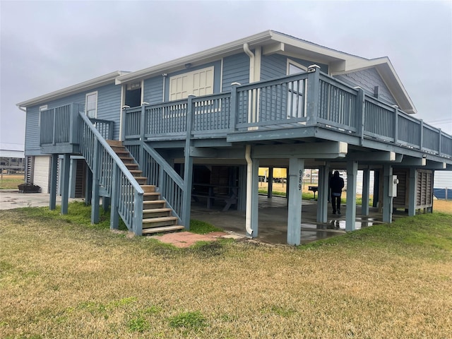 rear view of property with a wooden deck and a lawn