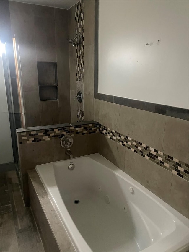 bathroom with hardwood / wood-style flooring and plus walk in shower