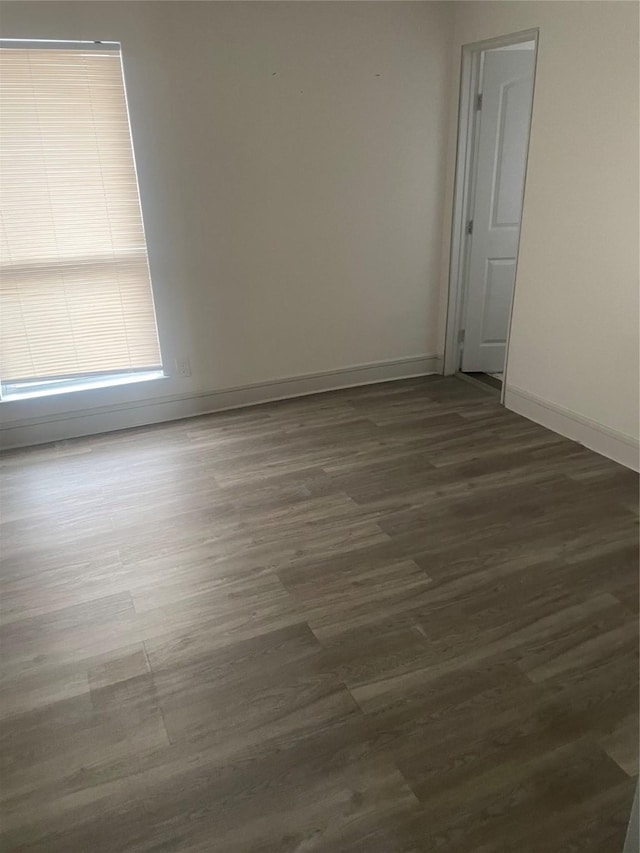 unfurnished room with dark hardwood / wood-style floors