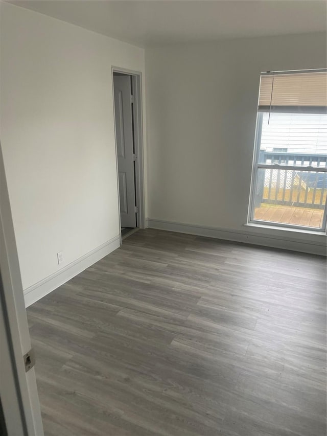 spare room with dark wood-type flooring