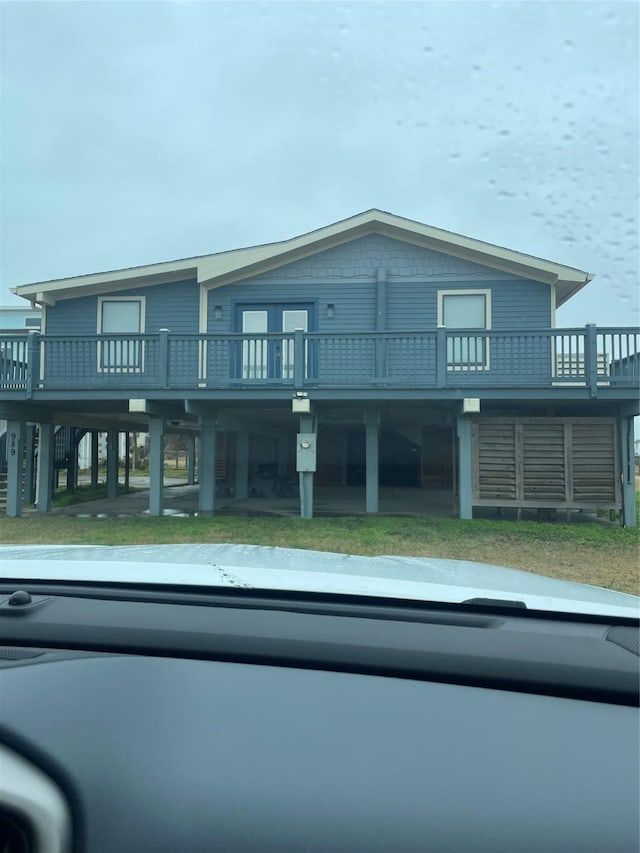 view of front of home with a front yard and a deck