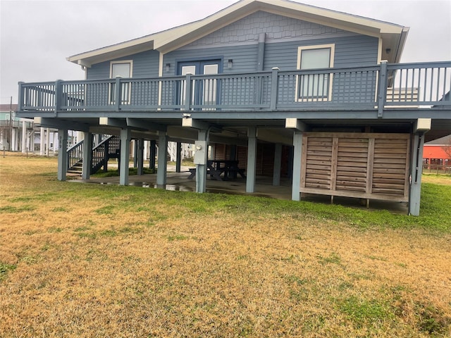 back of house with a wooden deck and a lawn