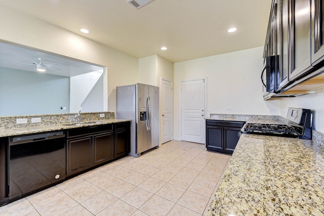 kitchen with sink, black appliances, ceiling fan, and light stone countertops