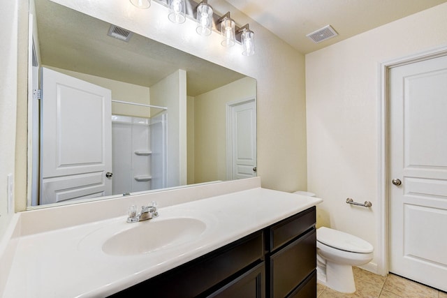 bathroom featuring walk in shower, tile patterned floors, toilet, and vanity