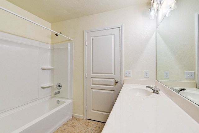 bathroom featuring tile patterned flooring, vanity, and washtub / shower combination