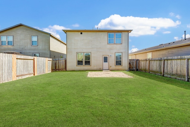 rear view of property with a lawn