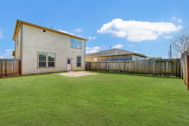 back of property featuring a yard and a patio area