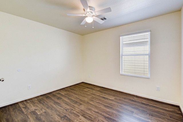 empty room with dark hardwood / wood-style floors and ceiling fan