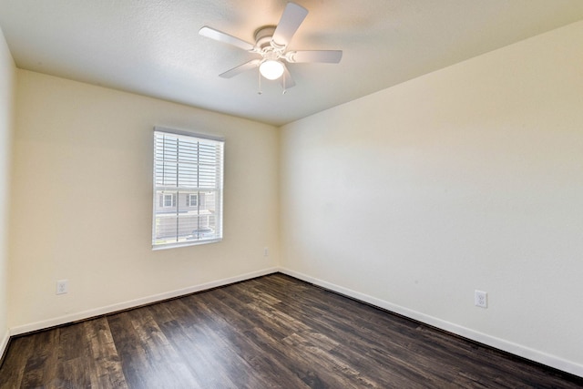 empty room featuring ceiling fan and dark hardwood / wood-style floors