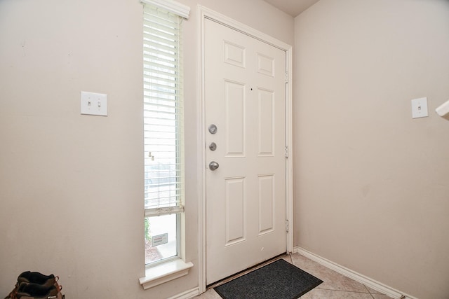 doorway to outside featuring light tile patterned flooring