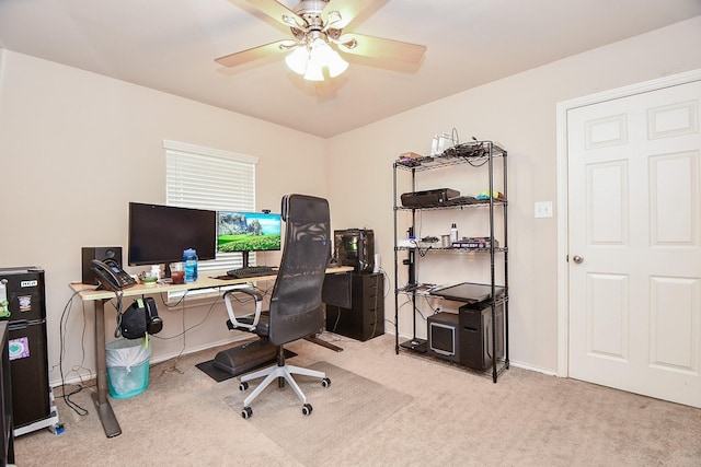 carpeted office space featuring ceiling fan