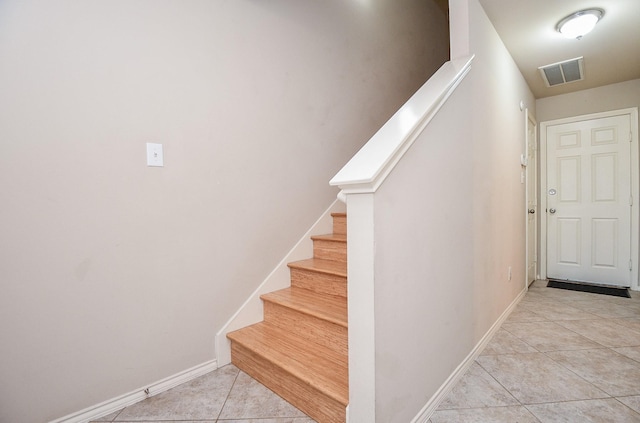 stairway featuring tile patterned floors