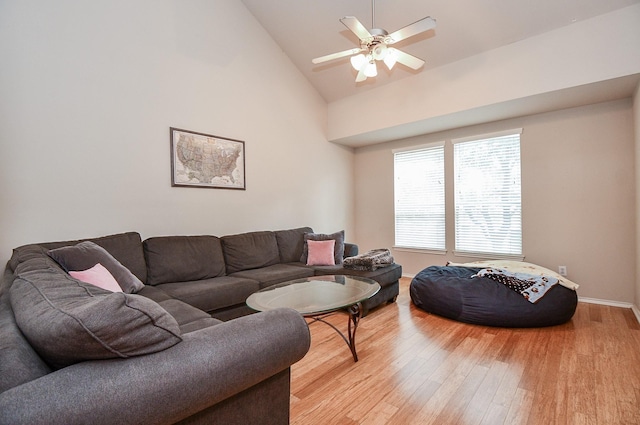 living room featuring ceiling fan, high vaulted ceiling, and light hardwood / wood-style flooring