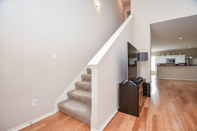 staircase featuring hardwood / wood-style floors