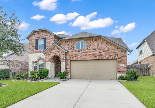 14615 Bent Gulch Ln, Cypress, TX 77429 - traditional-style home with roof with shingles, brick siding, fence, a front lawn, and concrete driveway