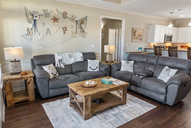 living room featuring ornamental molding and dark hardwood / wood-style floors