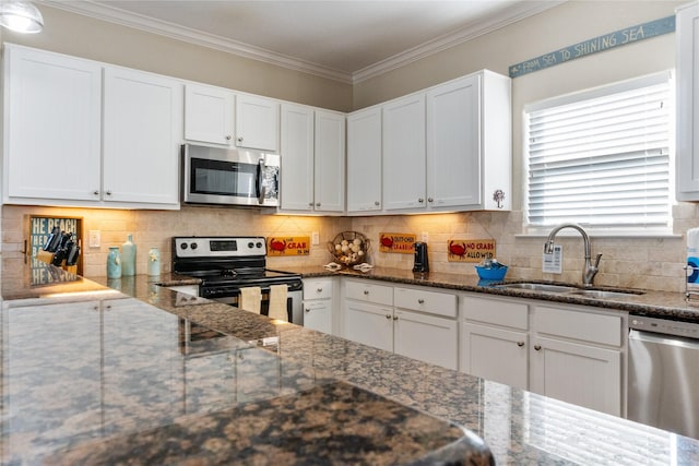 kitchen with white cabinetry, sink, dark stone counters, and appliances with stainless steel finishes