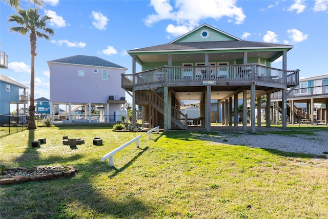 rear view of house with a deck and a lawn