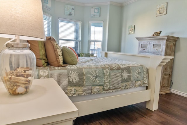 bedroom featuring crown molding and dark wood-type flooring