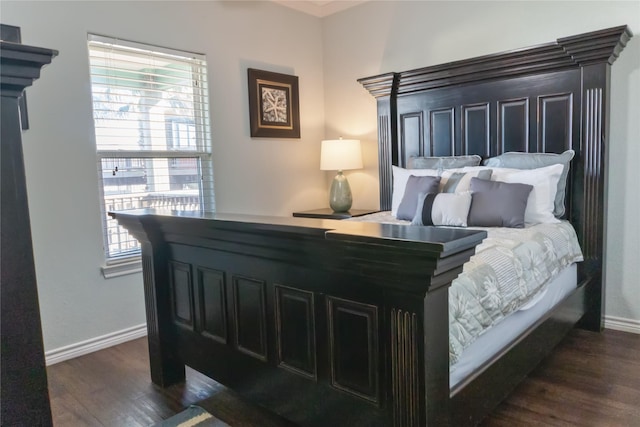 bedroom with dark wood-type flooring