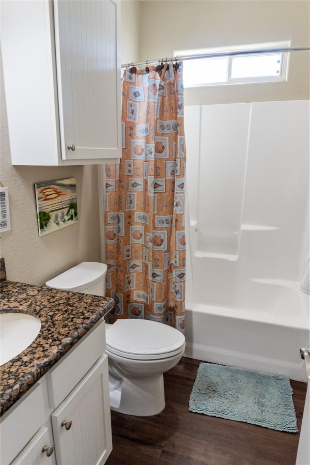 full bathroom featuring shower / tub combo, hardwood / wood-style floors, vanity, and toilet