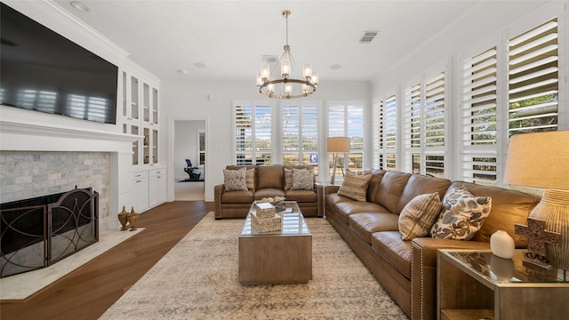 living room with a notable chandelier, crown molding, and dark wood-type flooring