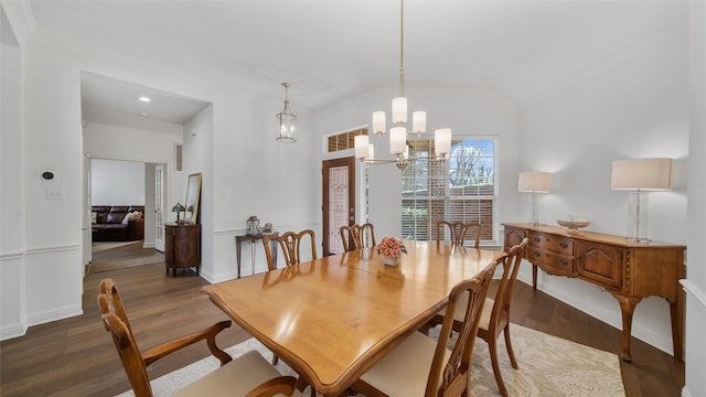 dining area featuring an inviting chandelier, hardwood / wood-style flooring, and ornamental molding