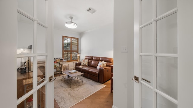 interior space featuring crown molding and wood-type flooring