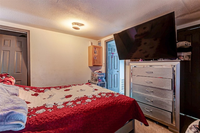 bedroom with carpet and a textured ceiling