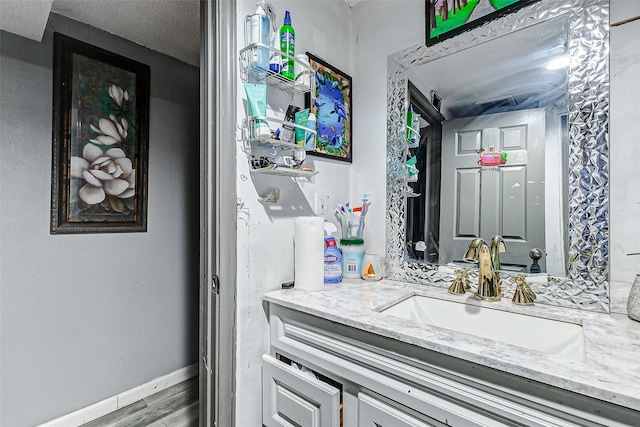 bathroom featuring hardwood / wood-style flooring and vanity