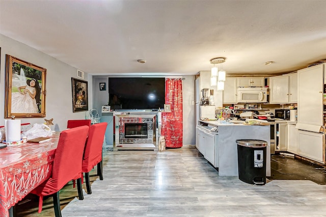 kitchen featuring light hardwood / wood-style floors and pendant lighting