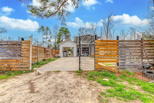 view of gate with an outdoor structure