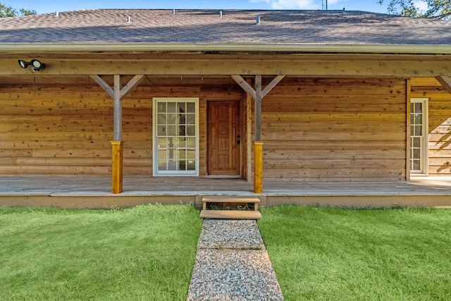 doorway to property with a yard