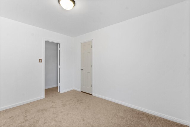 empty room with light colored carpet