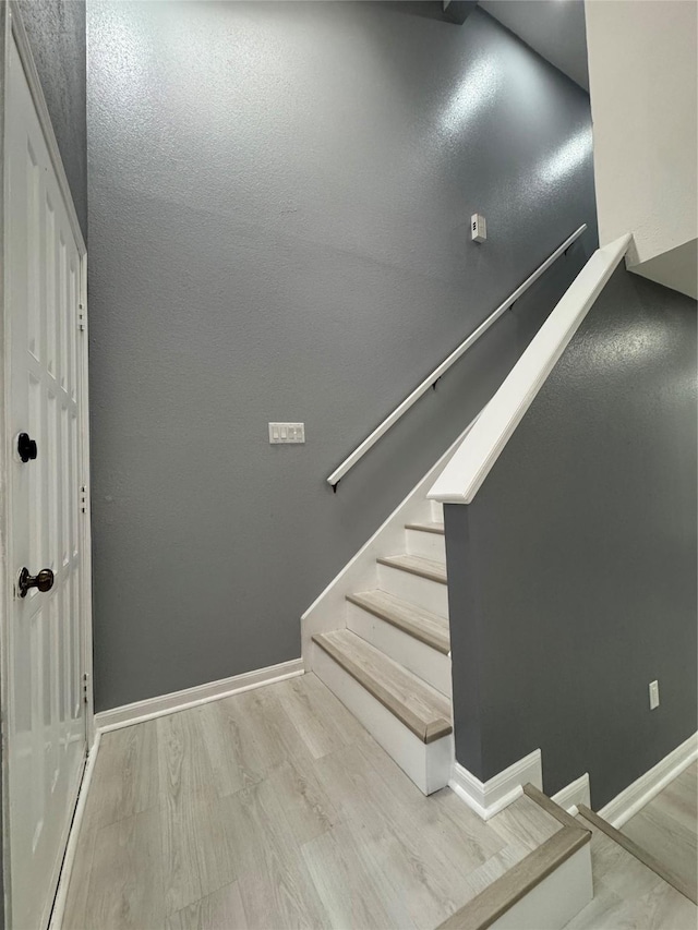 stairs with hardwood / wood-style floors