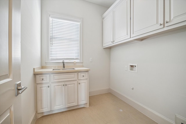 laundry area with sink, hookup for a washing machine, and cabinets