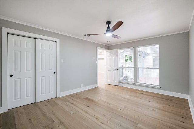 unfurnished bedroom featuring ceiling fan, a closet, ornamental molding, and light hardwood / wood-style flooring