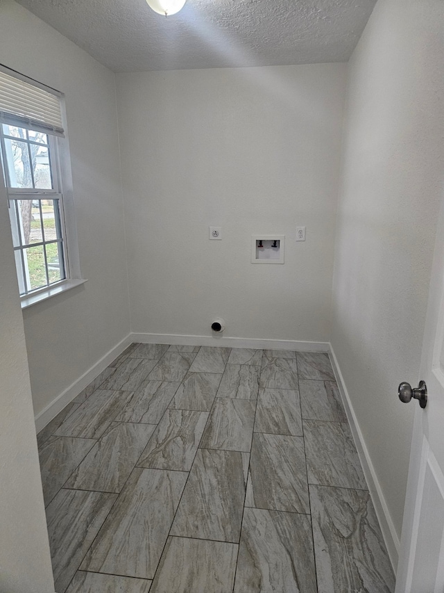 clothes washing area featuring washer hookup, hookup for an electric dryer, and a textured ceiling