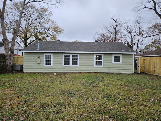 rear view of house featuring a yard and central air condition unit