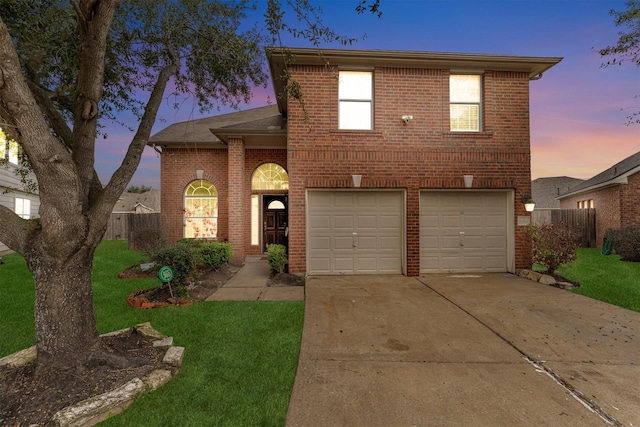 front of property featuring a garage and a yard