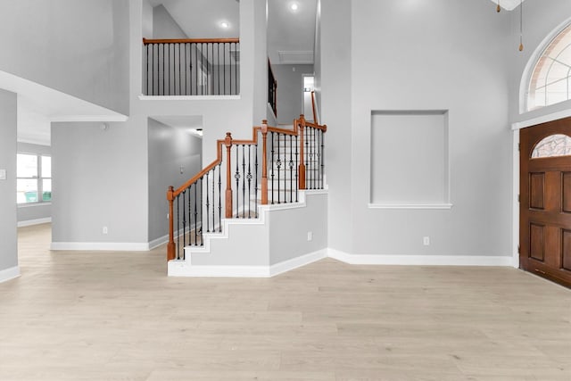 foyer featuring a high ceiling and light wood-type flooring