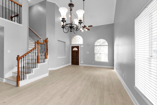 foyer featuring a notable chandelier, light hardwood / wood-style floors, and a high ceiling