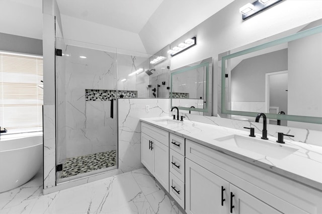 bathroom with vanity and shower with separate bathtub