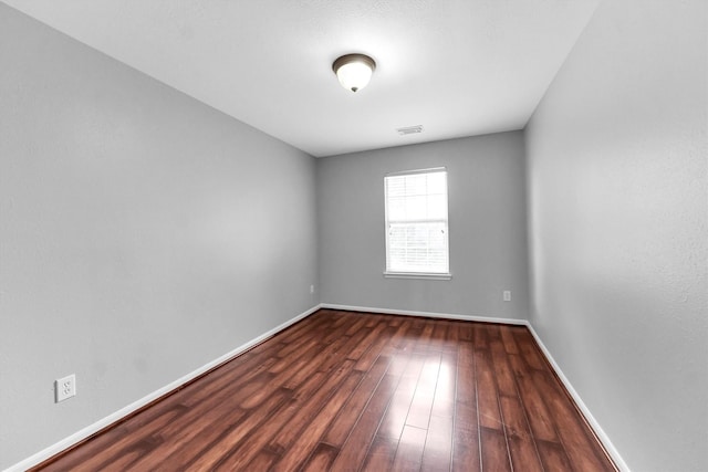 empty room featuring dark wood-type flooring